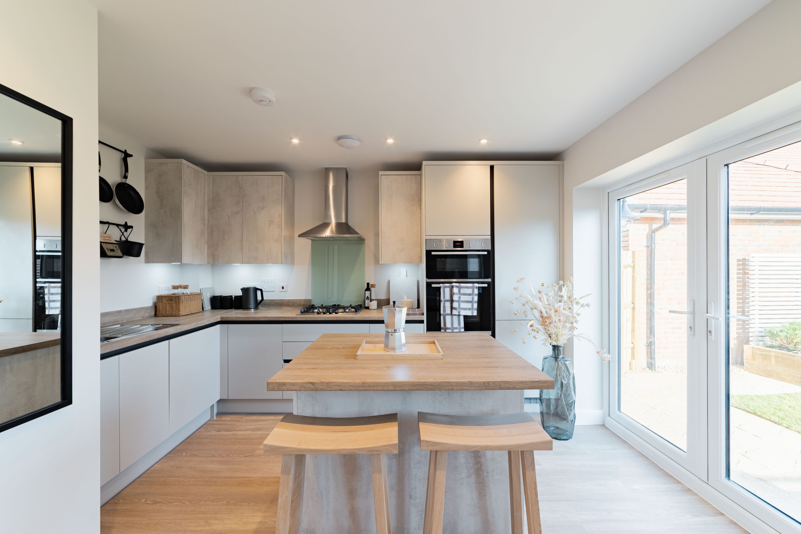 Bargate Homes Rivercross bedroom with large window, neutral tones, and soft furnishings