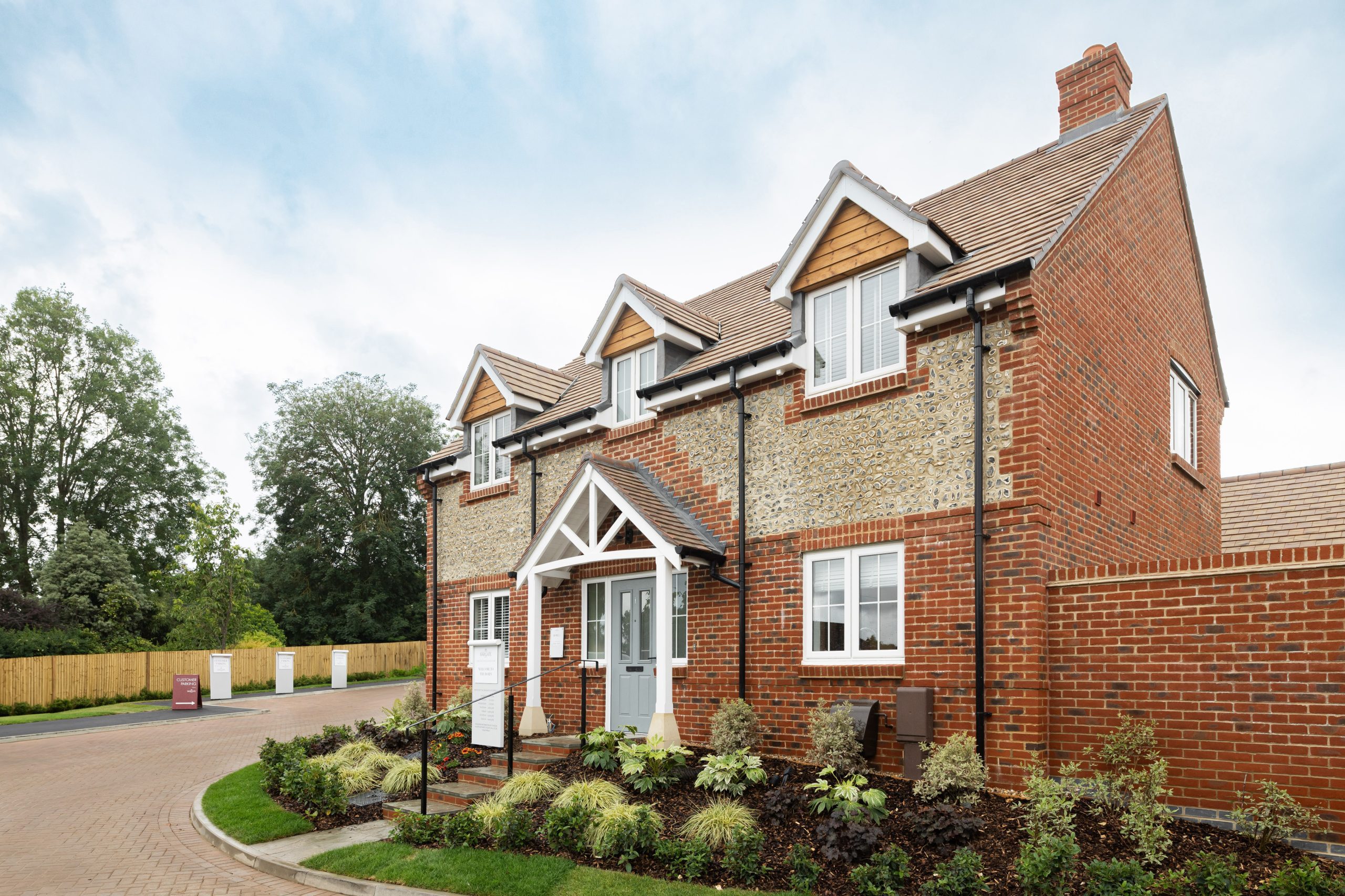 Newly built detached red-brick home with flint detailing, located at Bargate’s Norton Chase development