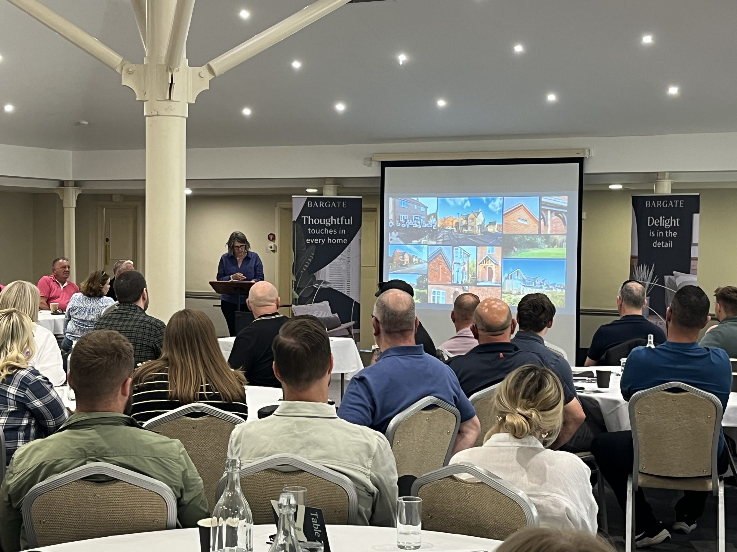 Company-wide strategy day presentation attended by Bargate Homes staff, featuring future development visuals